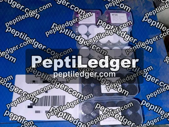 Boxes of vials and a courier label inside a blue courier bag